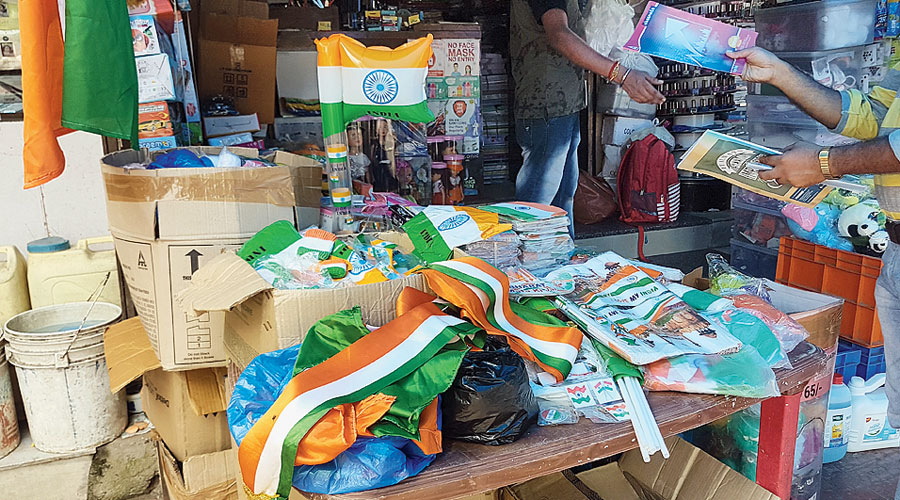 An inflatable flag stands tall among other Independence Day merchandise at Needs outside Baisakhi Abasan