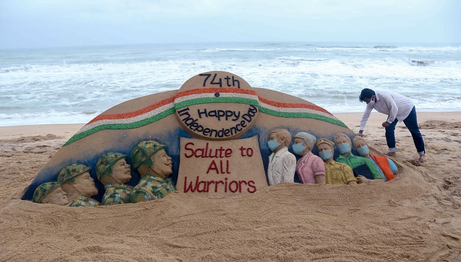 Sand artist Sudarsan Pattnaik creates a sand sculpture with message Salute to All Warriors on the eve of 74th Independence Day, at Puri beach.