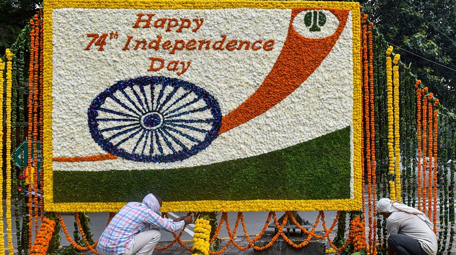 NDMC workers decorate a board with flowers to wish people on 74th Independence Day, in New Delhi.