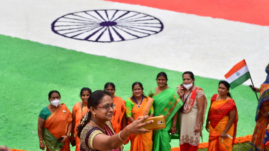 Teachers of Sapthagiri Engineering College click pictures after making 4000 sqft Tricolor rangoli as part of the 74th Independence Day celebrations, in Bangalore