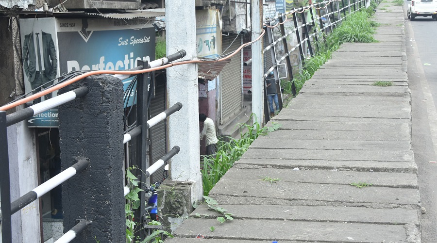 A portion of the railing on the footpath is broken, leaving pedestrians at risk.