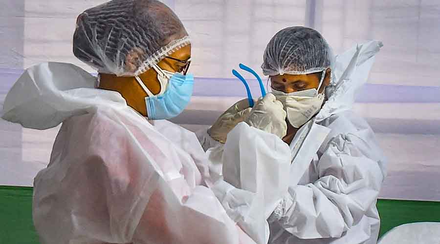 Medics wearing PPE kit prepare to collects samples for Covid-19 rapid antigen test, during unlock 3.0, at a centre in Calcutta, Monday, August 17, 2020. 