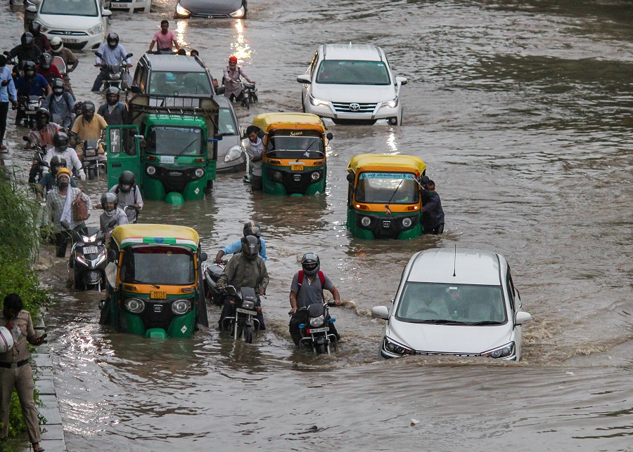 Vehicles move through waterlogged Hero Honda Chowk near Delhi-Gurgaon Expressway after heavy rain, in Gurugram on Wednesday