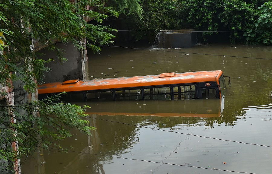 A DTC bus submerged in a waterlogged area following heavy rains, at Pul Pehlad Pur in New Delhi on Thursday.