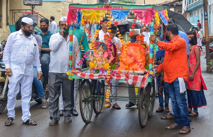 Devotees carry an idol of Lord Ganesha for installation on the occasion of Ganesh Chaturthi, in Karad on Friday.