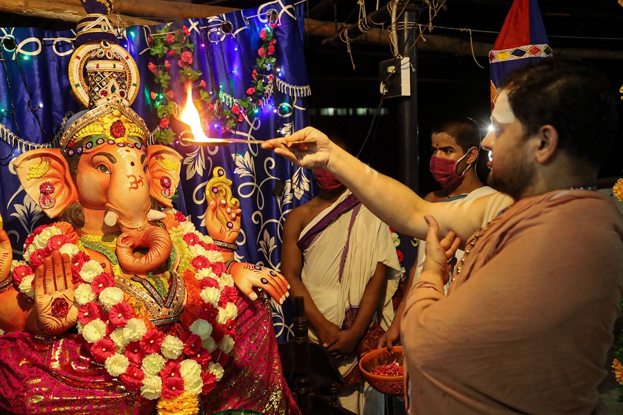 A priest performs aarti in front of an idol of Lord Ganesh, at Thali Sree Maha Ganapathi Balasubramanya Temple in Kozhikode on Friday.