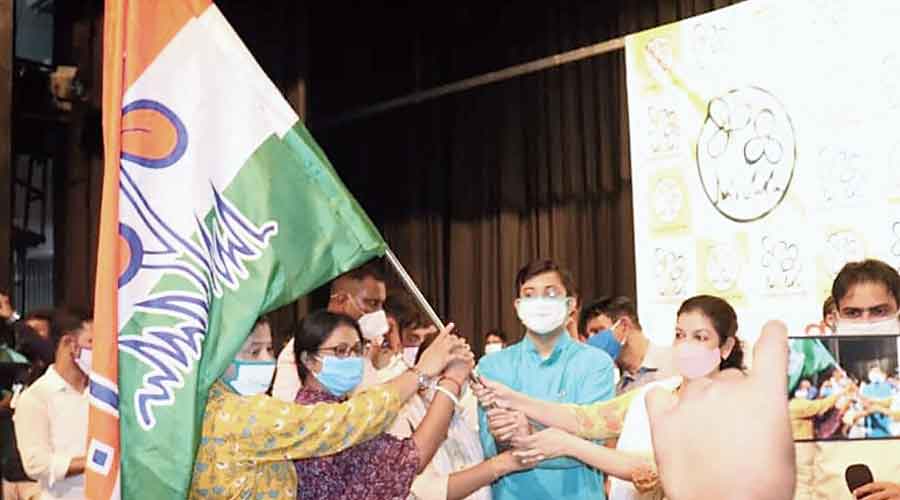 Youths receive Trinamul flags from Mausam Noor in Malda on Sunday