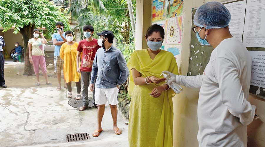 Residents of Surjakiran queue up for rapid antigen tests.