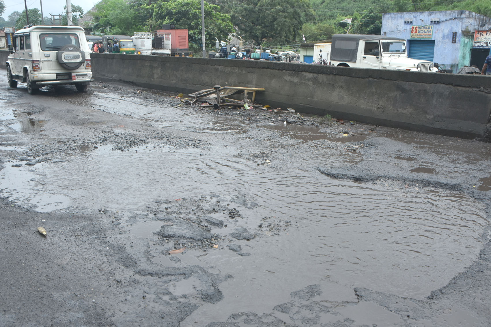 Water logged in potholes on Jharia-Dhanbad road at Ena-Islampur area in Jharia, Dhanbad on Monday