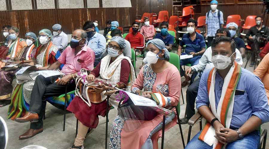 Covid warriors from the Calcutta Municipal Corporation’s Borough III after their felicitation at the civic body’s solid waste management department in Narkeldanga on Tuesday