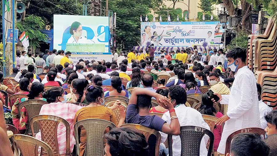 Students watch Mamata’s address on a giant screen at Chandernagore on Friday. 