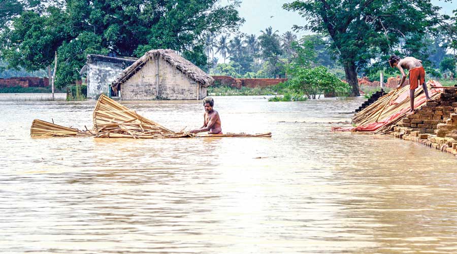 Residents shift from a flooded village near the banks of river Bhargavi in Odisha’s  Khordha district on Saturday. 