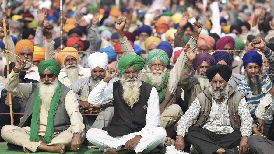 Farmers stage protest at the Singhu border on Tuesday.