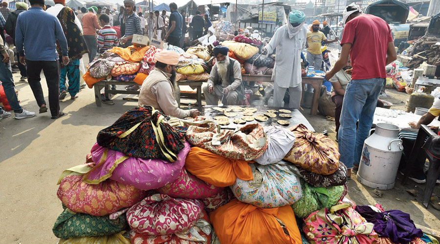Farmers cook for their fellow protesters at Singhu border on Friday.
