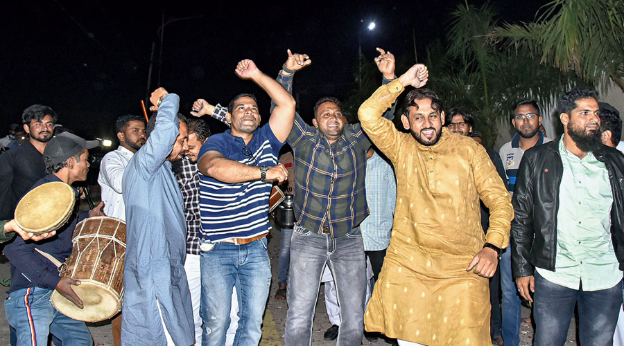 AIMIM supporters celebrate outside the residence of their party president Asaduddin Owaisi after his lead in the Greater Hyderabad Municipal Corporation elections in Hyderabad on Friday.