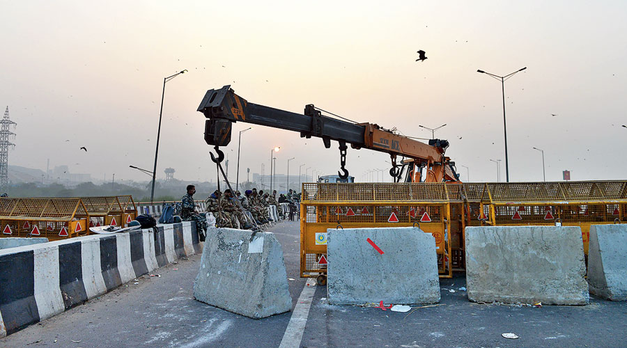 Police stand guard at a blocked border point between Delhi and Uttar Pradesh.