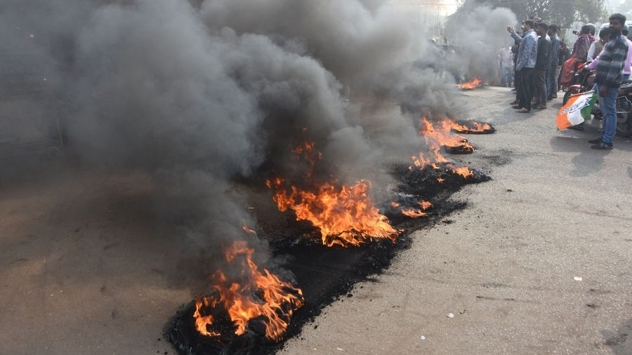 Congress workers burn tyres during their demonstration in Dhanbad on tuesday.