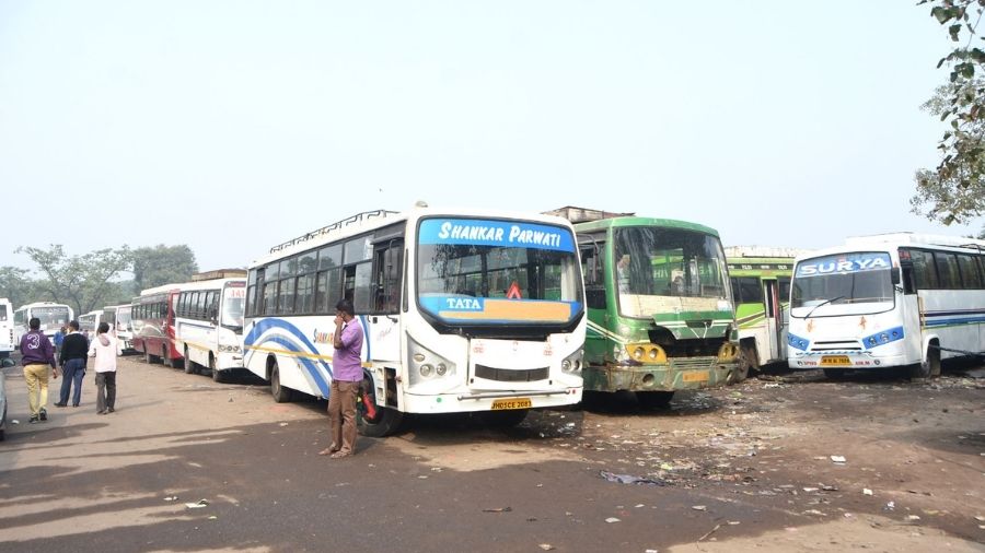 Long distance buses stand at Dhanbad bus stop in Bartand, Dhanbad, as operations remain suspended on Tuesday.