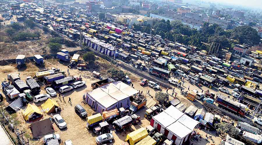 A river of trucks and tractors — home to protesting farmers for nearly two weeks — stretches for nearly 12km at the  Singhu border near Delhi on Wednesday. 