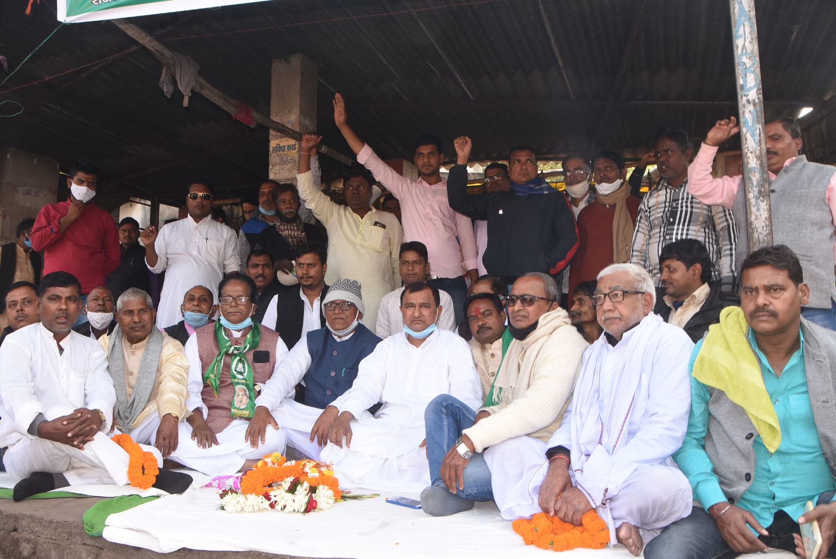 RJD leaders stage a dharna against the new farm laws at Randhir Verma Chowk in Dhanbad on Monday.