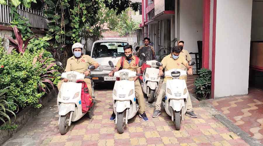 Postmen on their e-scooters at Bhowanipore post office