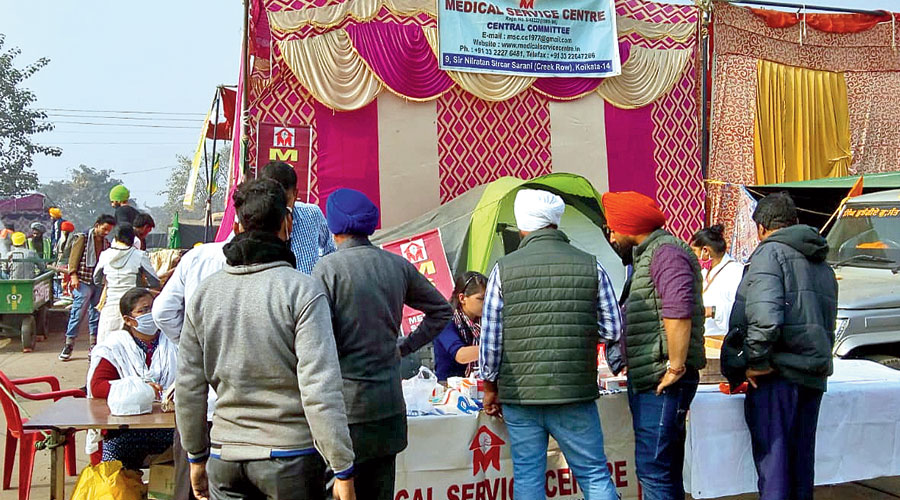 Protesters at the Singhu border line up at the camp run by the doctors from Calcutta.
