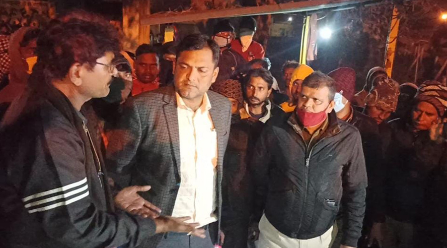 Nirsa circle officer M.N. Mansuri (in coat) and SDPO Bijay Kushwaha (with red mask) talk to a group of angry workers after the body of one of the trapped miners was recovered on Tuesday night at Mugma in Dhanbad. 