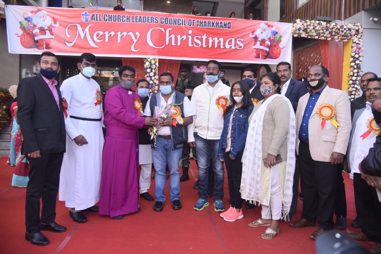 Attendees of the Christmas gathering at Ranchi receive flower bouquets from the Church authorities on Tuesday.