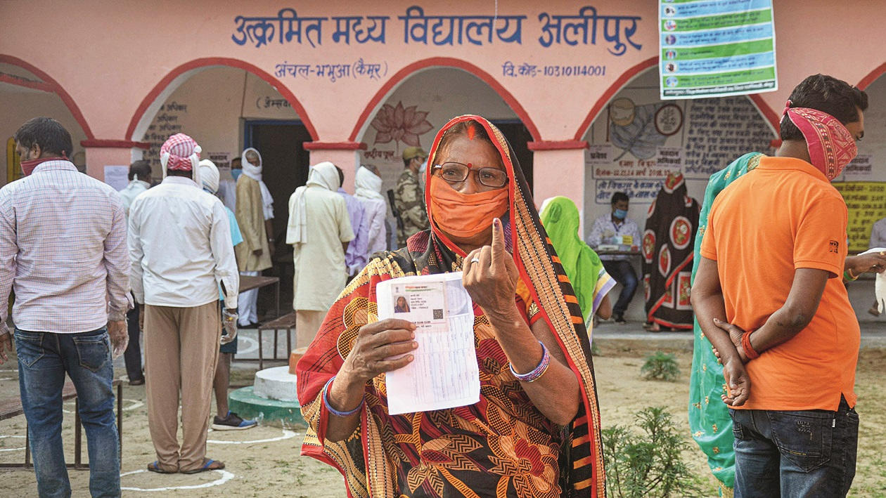 A voter shows her finger marked with indelible ink after casting her vote for the first phase of Bihar Assembly Election, amid the coronavirus pandemic, at Bhabhua police station in Kaimur district, Wednesday, Oct. 28, 2020.