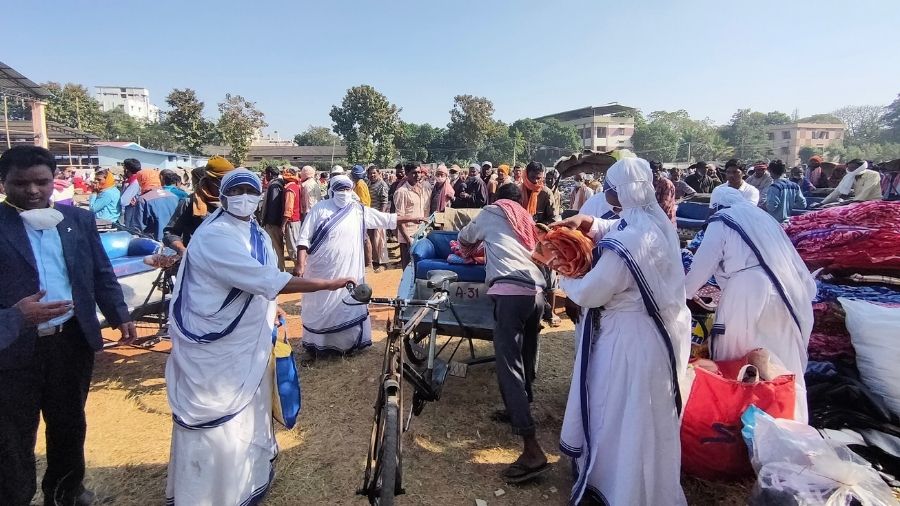 Nuns provide blankets to a rickshaw puller on the occasion of Christmas Loyola Ground in Ranchi on Friday.
