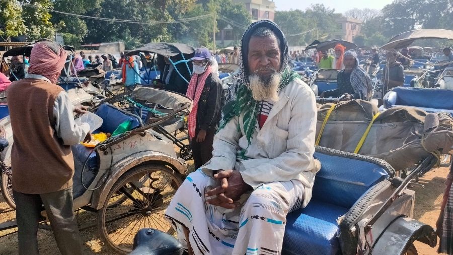 An old man waits on his rickshaw on the Loyola Ground, where thousands were provided with food and blankets on Friday by church authorities.