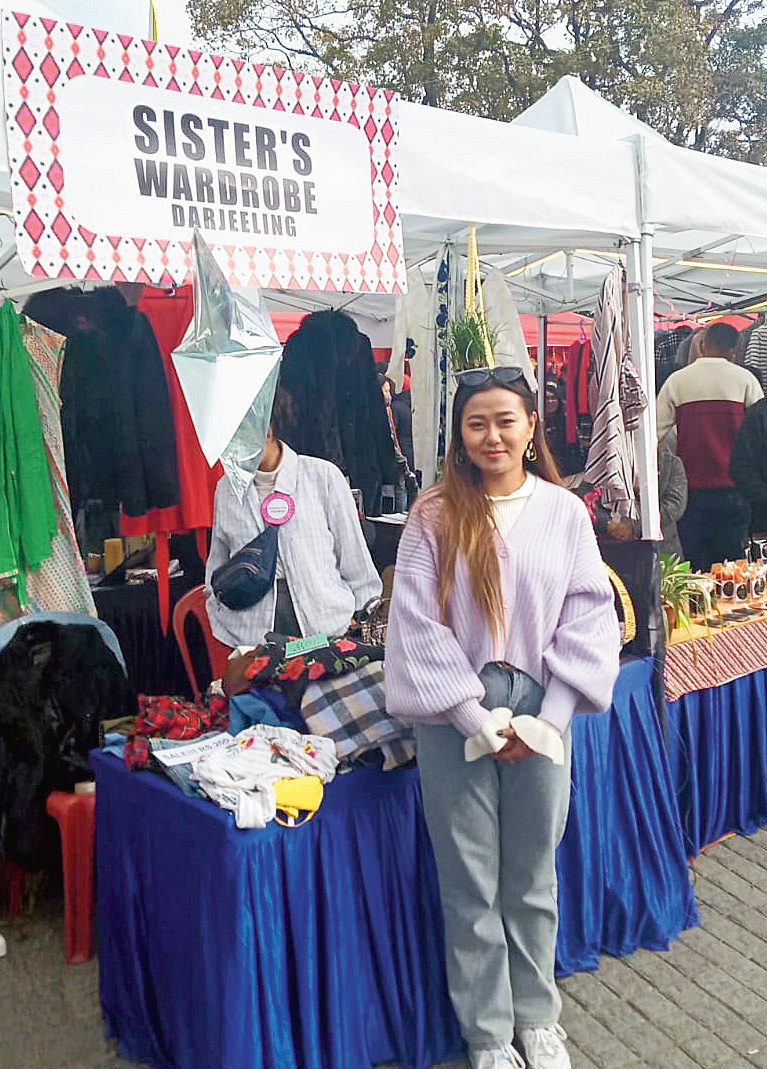 Cynthya with her clothes at her stall in Gundri Bazaar, Darjeeling.