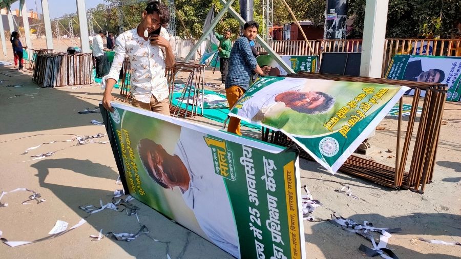 A worker carries a banner describing the achievements of the Hemant Soren government, which is set to be put up on the December 29 programme, at the Morabadi Stadium in Ranchi, on Sunday.