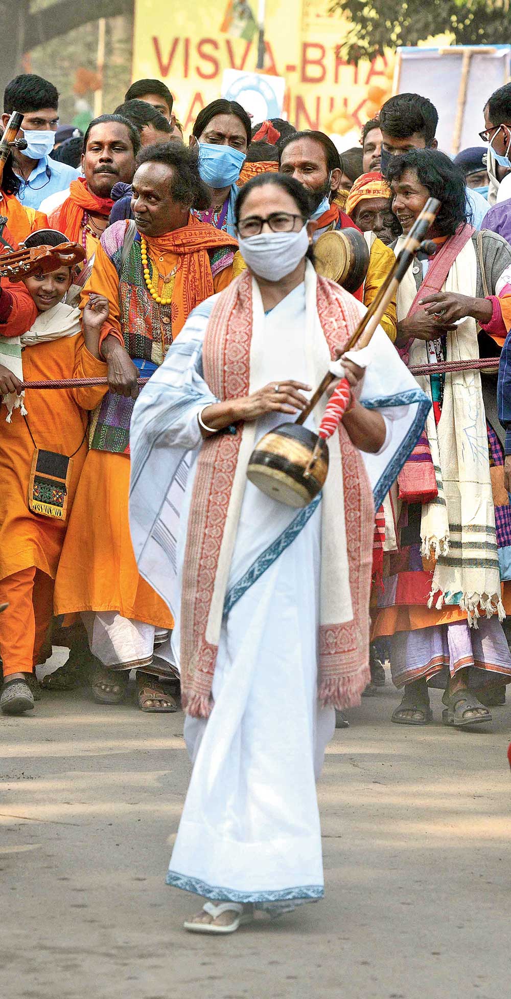 Mamata takes up a stringed instrument.