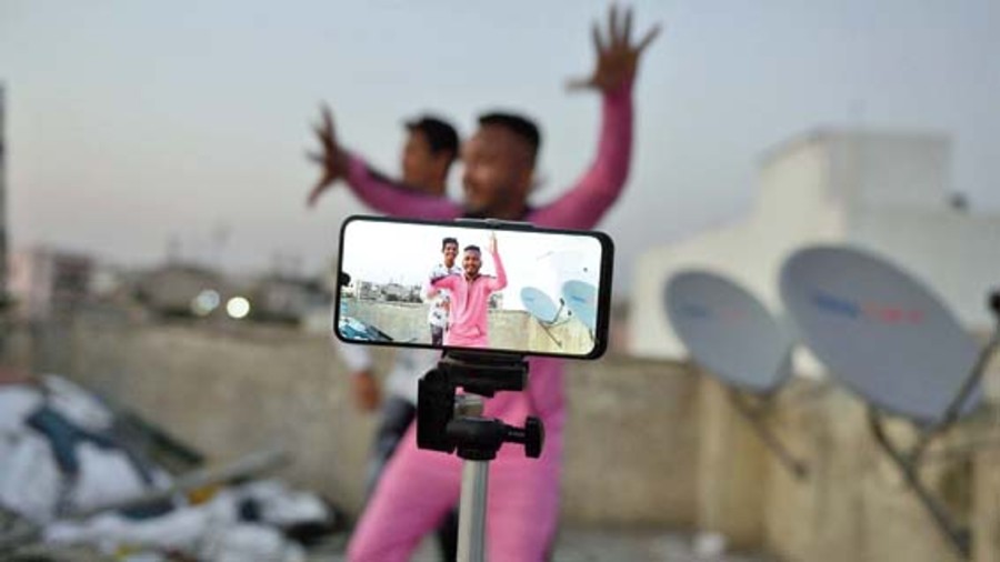 People making a TikTok dance video on the terrace of their residence in Hyderabad