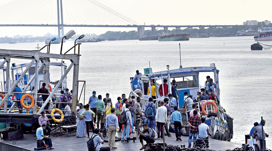 Commuters board ferries at Babughat on Tuesday. 