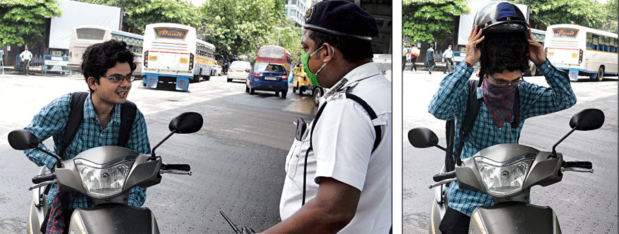 A biker without a mask and helmet is persuaded to wear them