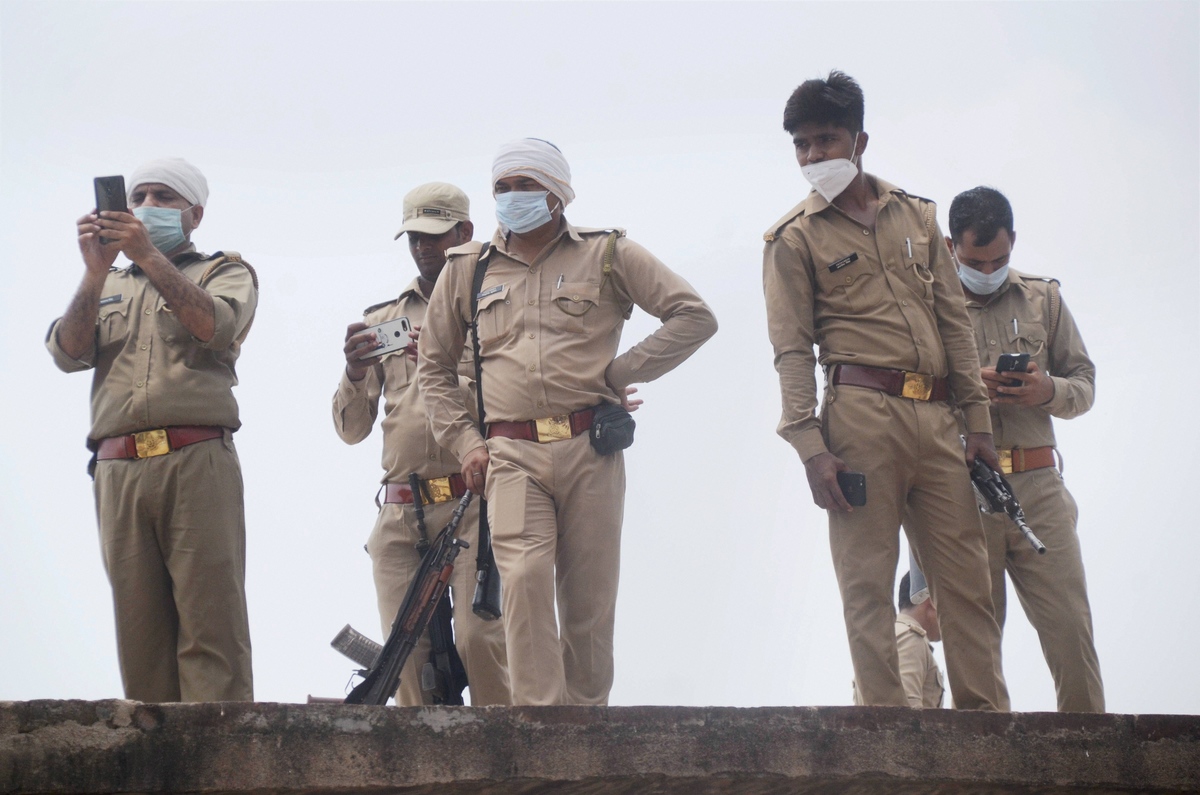 Police personnel at the residence of criminal Vikas Dubey after an encounter where 8 cops were killed, in Kanpur, Saturday, July 4, 2020