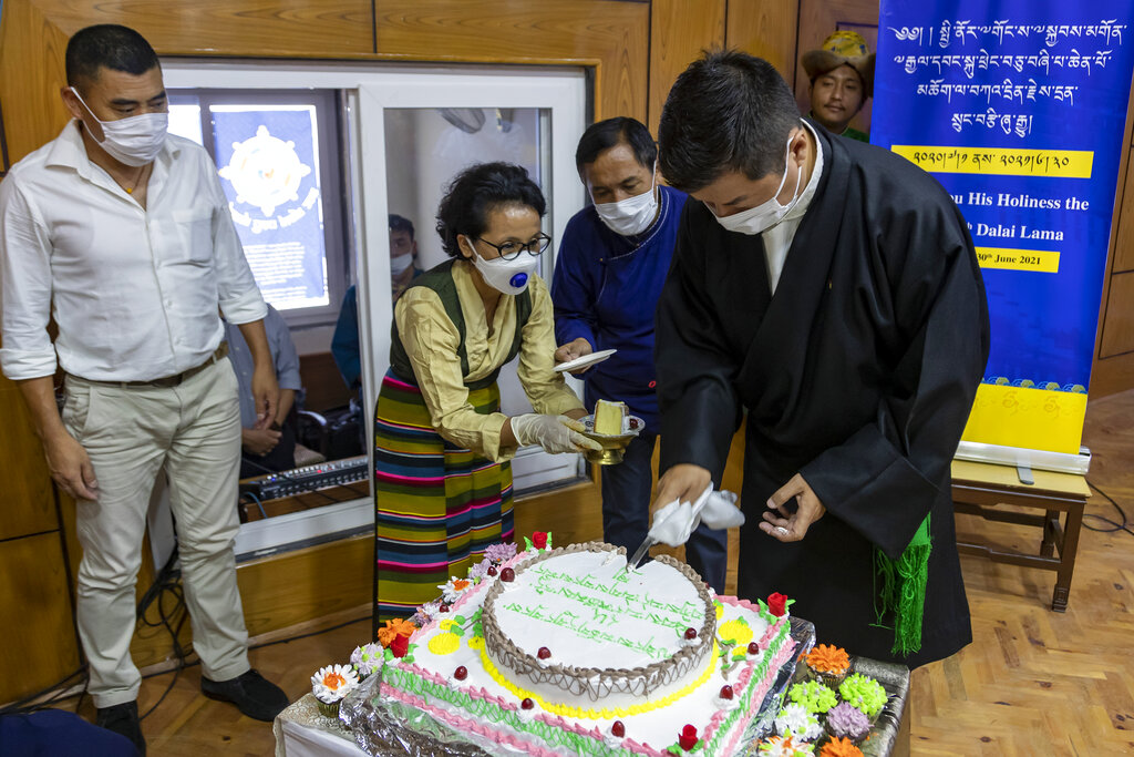 Lobsang Sangay, the president of the Central Tibetan Administration cuts a cake to mark his spiritual leader the Dalai Lama's 85th birthday in Dharmsala, India, Monday, July 6, 2020. 