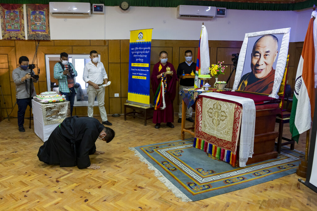 Lobsang Sangay, the president of the Central Tibetan Administration bows in front of a portrait of his spiritual leader the Dalai Lama during an official function to mark the the Tibetan leader's 85th birthday in Dharmsala, India, Monday, July 6, 2020.