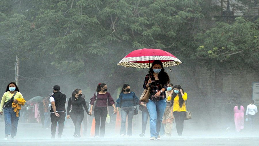 People walk along the ridge during rainfall, in Shimla, Tuesday, July 7, 2020.