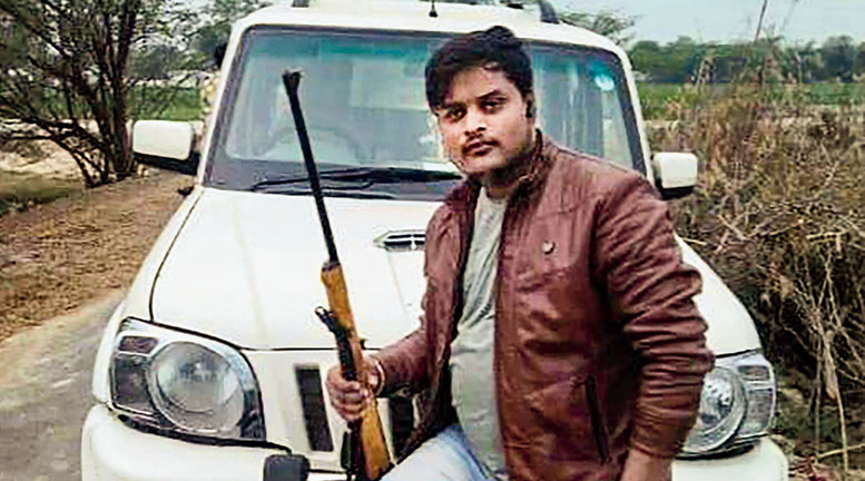 Amar with a gun in an undated picture.