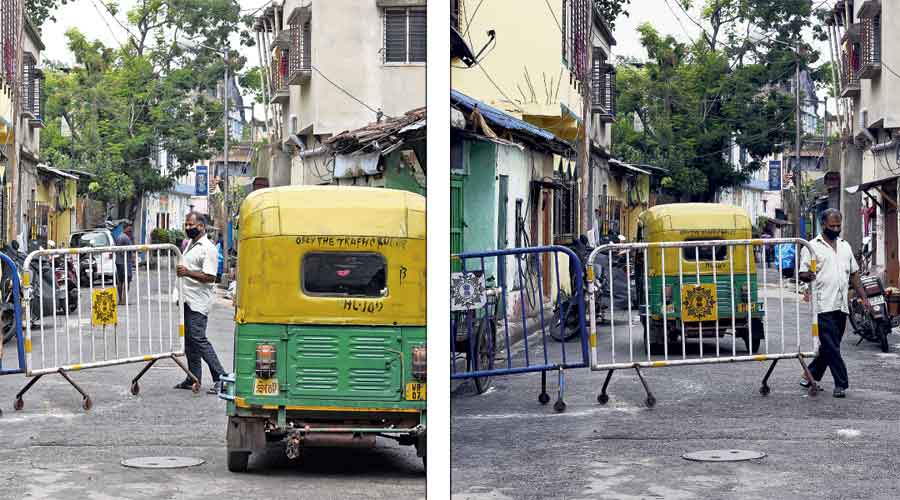 A man moves a guardrail on Maratha Ditch Lane in Bagbazar, drives in with his auto and (right) then replaces it