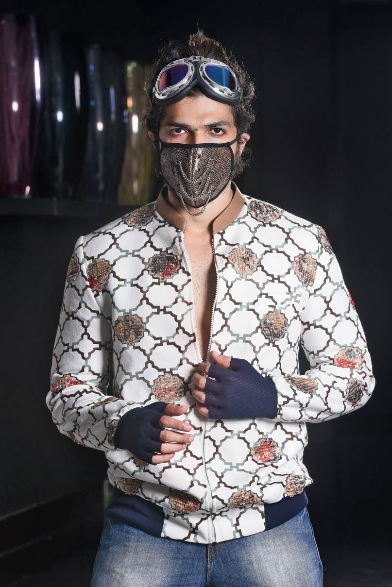 The graphic bomber comes with in-built gloves and has been teamed with a “pure leather mask” and biker shades. “The mask is our signature. Since we are talking about safe fashion, the biker shades work well because it covers most of your face,” says Abhishek. #QuirkyHandsome    