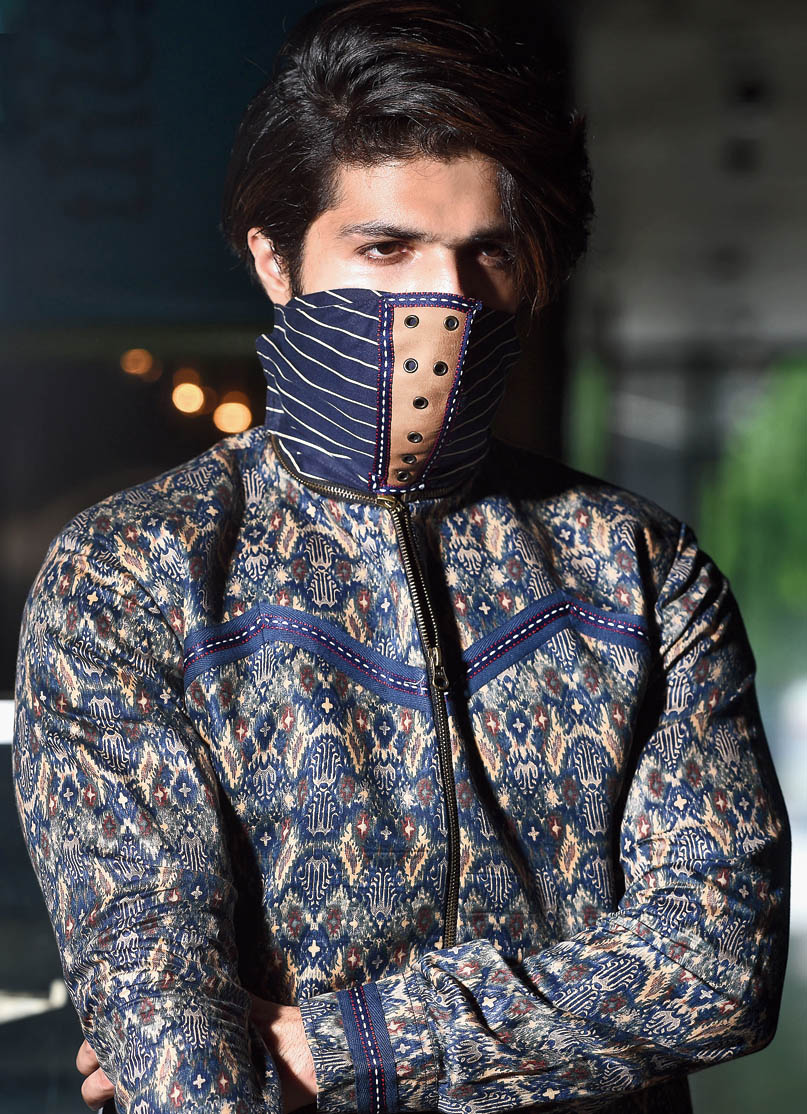 This bomber jacket comes with a wrap-around detachable mask with Velcro detailing. 