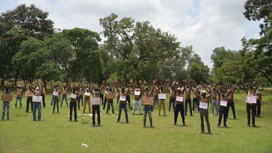 Former contract labourers of HURL Sindri demonstrating naked in front of the HURL factory main gate in Sindri, Dhanbad