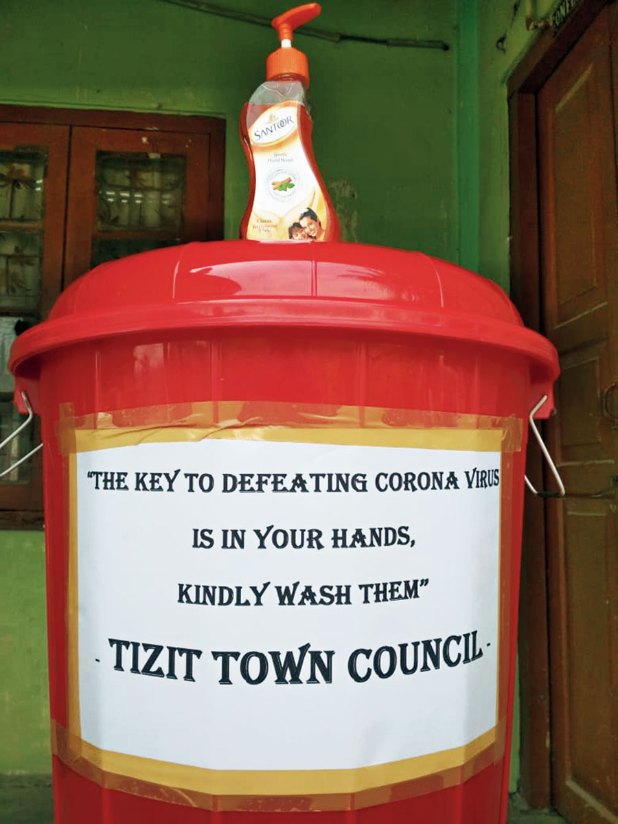 A water tank with a message on how to check the spread of coronavirus in Mon district.