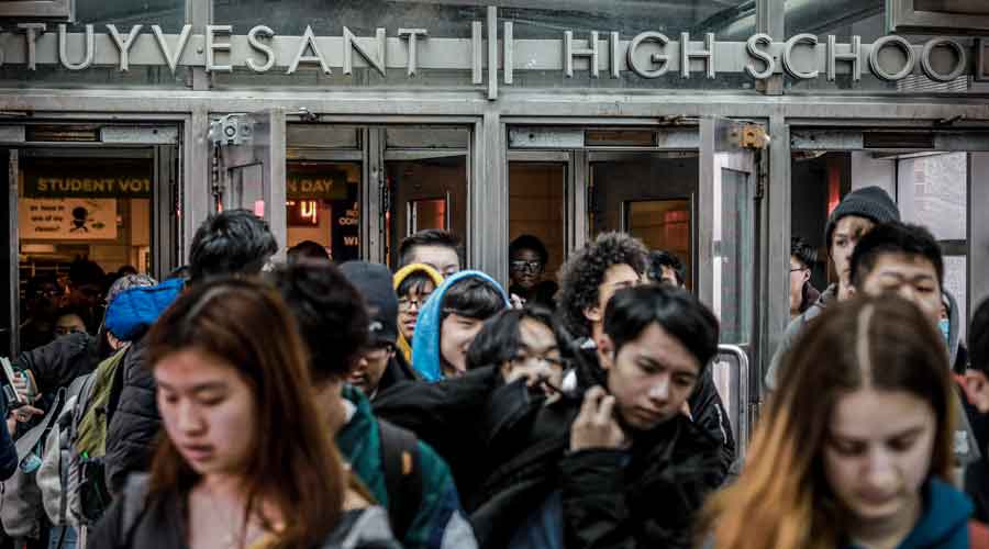 Students at Stuyvesant High School leave after classes in New York at the onset of the coronavirus pandemic