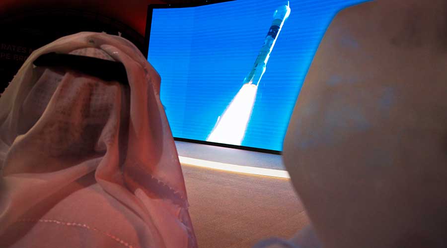 Emirati men watch the launch of the 