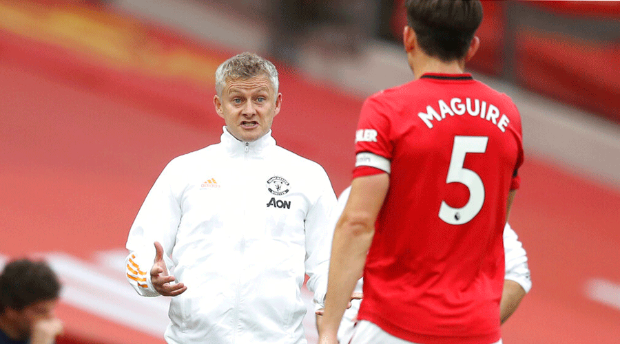 Ole Gunnar Solskjaer talks to Harry Maguire during the EPL match between Manchester United and West Ham at the Old Trafford stadium on Wednesday.